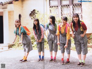 A group of young women standing in front of a building.