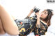 A woman laying on a bed holding a camera.